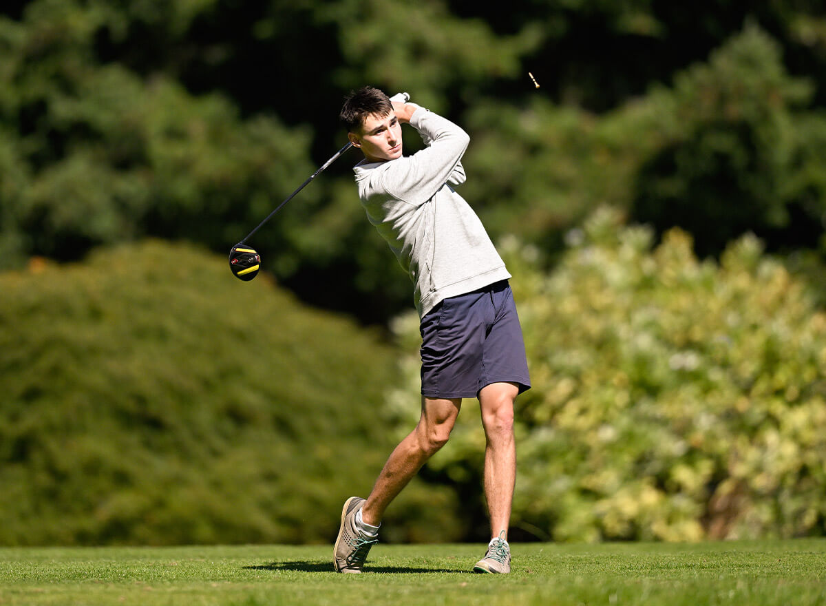 Photo of a golfer after he has swung and hit the golfball out of the frame