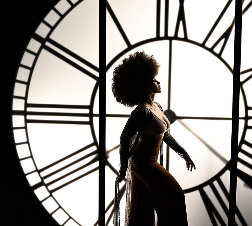 Jerry Ghionis photo of a woman in front of a large clock face